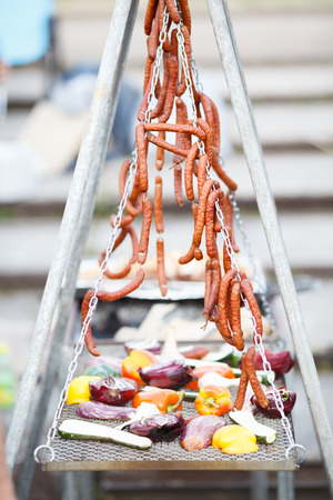 Grilled vegetables and hunting sausages cooking on street. With copy spaceの写真素材
