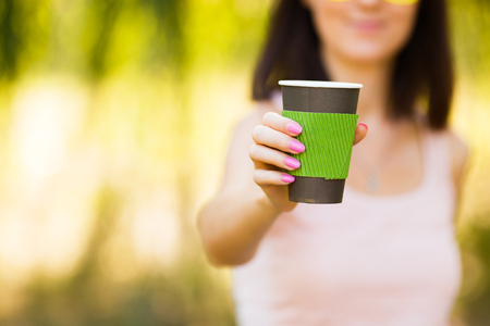 nice girl with a paper cup of coffeeの写真素材