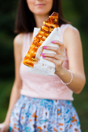 piece of pizza in the girls handの写真素材