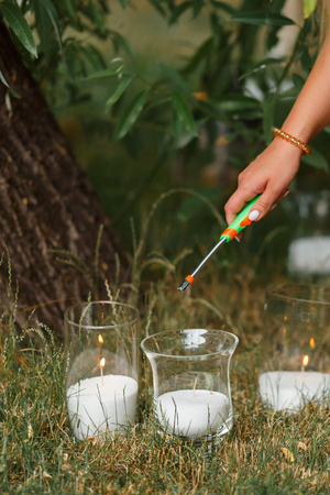 Beautiful burning candles in glass transparent vases. Intimate romantic atmosphere, burning candlesの写真素材