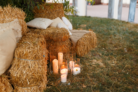 christmas, celebrating concept. lights of burning candles create atmosphere of comfort and cosiness, and fresh green branches are placed nearbyの写真素材