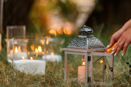 Beautiful burning candles in glass transparent vases. Intimate romantic atmosphere, burning candlesの写真素材