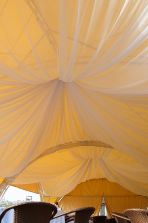 beautifully decorated wedding tent and wedding banquet on a background of skyの写真素材