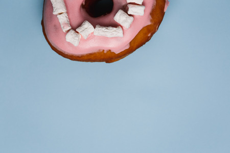 Pink donut with marshmallows on a blue backgroundの写真素材