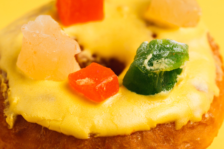 tasty yellow donut with lemon taste, isolated on yellowの写真素材