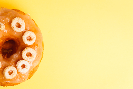 Honey Glazed doughnut or donut on a yellow background is a type of fried dough confectionery or dessert food.の写真素材