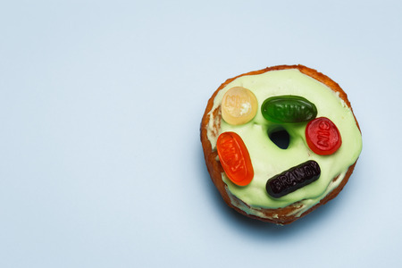 Donut with green glaze and colour marmaladeの写真素材
