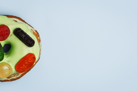 Donut with green glaze and colour marmaladeの写真素材
