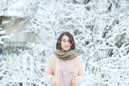cute girl with a pink cup of coffee in the winter forestの写真素材