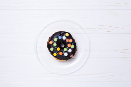 donut in sugar glaze on transparent plateの写真素材