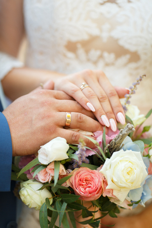 Hands of the lovers of the bride and groom. Wedding ringsの写真素材