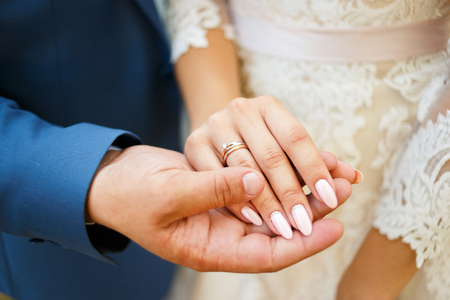 Hands of the lovers of the bride and groom. Wedding ringsの写真素材