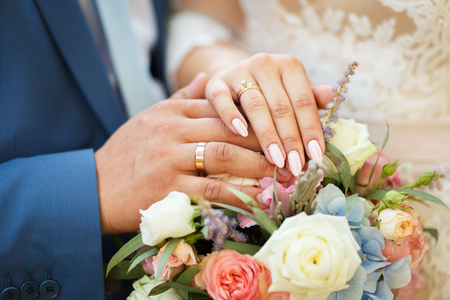 Hands of the lovers of the bride and groom. Wedding ringsの写真素材