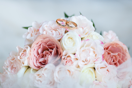 wedding golden rings with pastel pink roseの写真素材