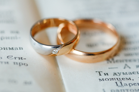 Engagement wedding gold rings on a bookの写真素材