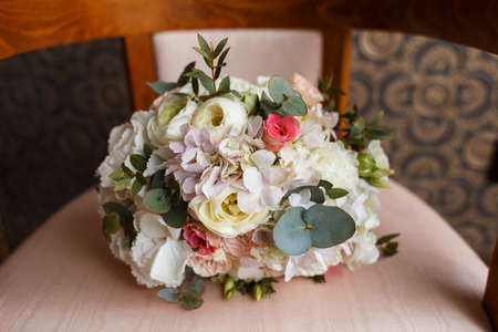 Wedding Sweet Bouquet of the Bride with roses and hydrangea in a retro Chairの写真素材