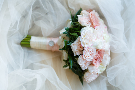 Beautiful and delicate wedding bouquet of flowers and roses of David Austin for the brideの写真素材