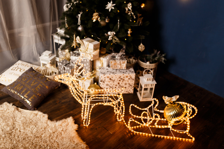 garland Christmas sleigh with Christmas deer glows against the night skyの写真素材