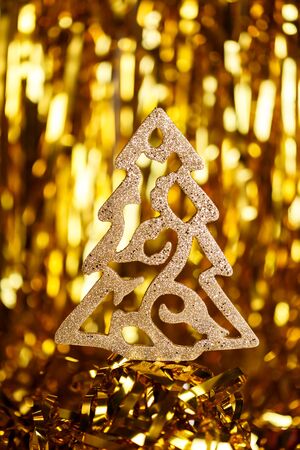 Golden christmas tinsel tree decoration on glitter Goldenの写真素材