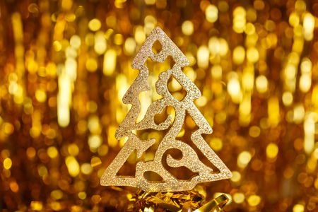 Golden Christmas tree on a gold backgroundの写真素材