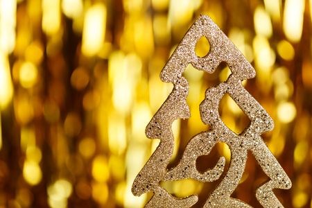 Golden Christmas tree on a gold backgroundの写真素材