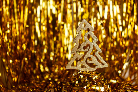 Golden Christmas tree on a gold backgroundの写真素材