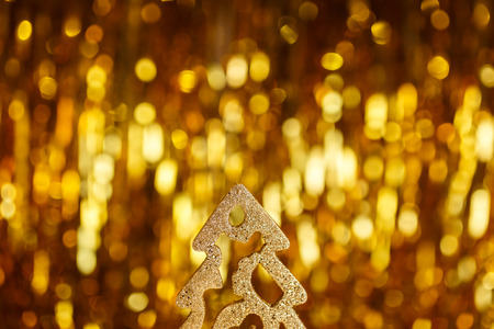 Golden Christmas tree on a gold backgroundの写真素材