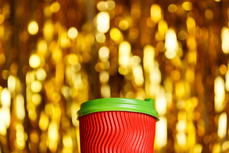Coffee to go in red cup and Christmas golden metafanの写真素材