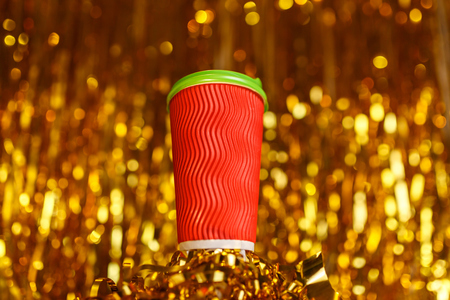 Coffee to go in red cup and Christmas golden metafanの写真素材