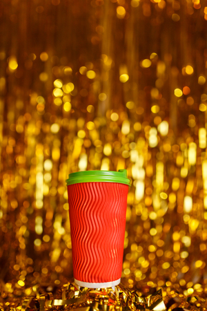 Coffee to go in red cup and Christmas golden metafanの写真素材