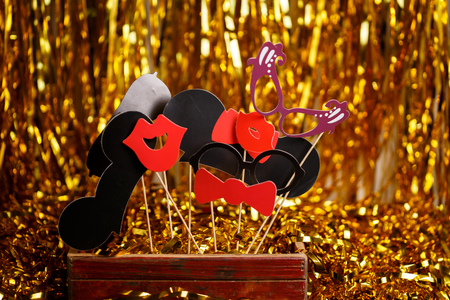 Paper accessories for holidays, birthday, parties, carnival and wedding celebration concept. Accessories for photobooths photoshooting on golden glitter background.の写真素材