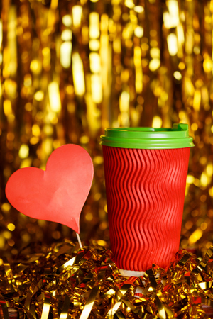Coffee in red cup with marshmallow and Christmas golden metafanの写真素材