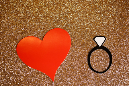 fake paper party engagement ring with gold glitter backdropの写真素材