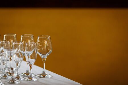 Empty glasses for wine and champagne in a row at the banquet tableの写真素材