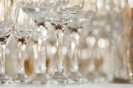 Empty glasses for wine and champagne in a row at the banquet tableの写真素材