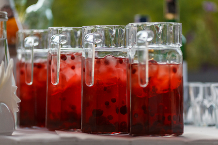 Decanters with cranberry lemonade and iceの写真素材