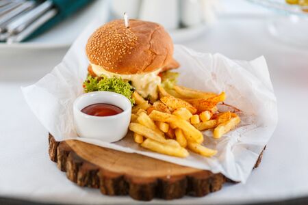 Tasty chicken burger with fresh fries. Concept of fast food.の写真素材