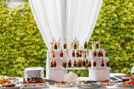 Appetizers with mozzarella and tomato in cocktail cups - selective focusの写真素材