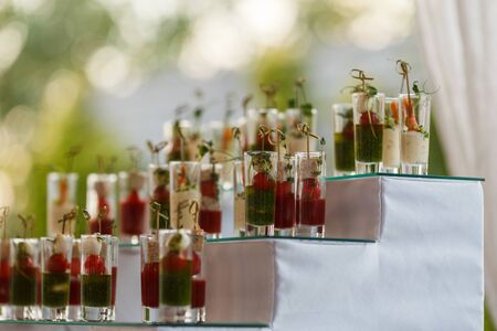 Appetizers with mozzarella and tomato in cocktail cups - selective focusの写真素材
