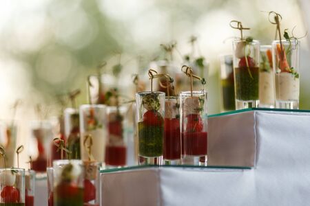 Appetizers with mozzarella and tomato in cocktail cups - selective focusの写真素材
