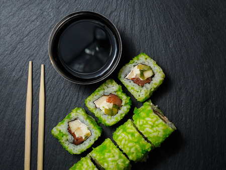 Japanese sushi rolls with soy sauce served on stone slate on dark background. Sushi background. Asian or Japanese food.の写真素材