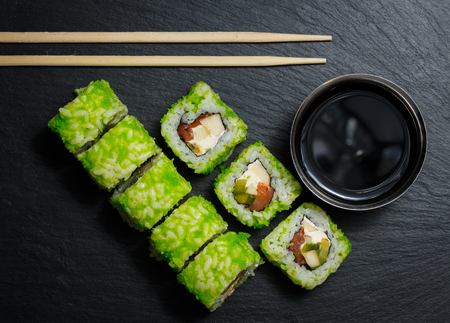 Japanese sushi rolls with soy sauce served on stone slate on dark background. Sushi background. Asian or Japanese food.の写真素材