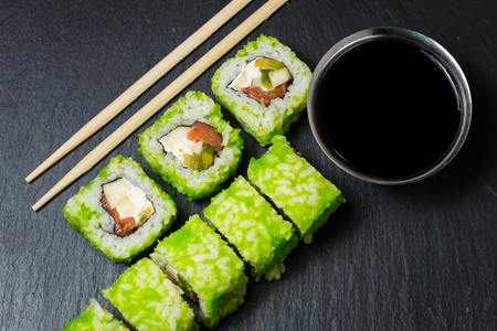 Japanese sushi rolls with soy sauce served on stone slate on dark background. Sushi background. Asian or Japanese food.の写真素材