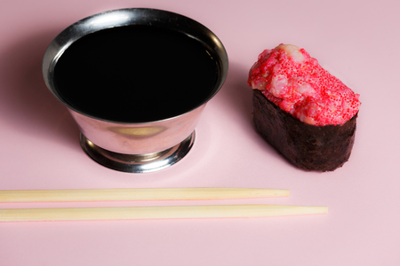 Japanese food Ebiko Gunganmaki. Shrimp roe gunship roll isolated on pink background.の写真素材