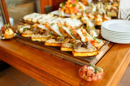 Catering Fourchette, buffet table, Canape, sandwiches and snacks on holiday tableの写真素材