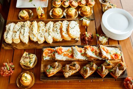 Catering Fourchette, buffet table, Canape, sandwiches and snacks on holiday tableの写真素材