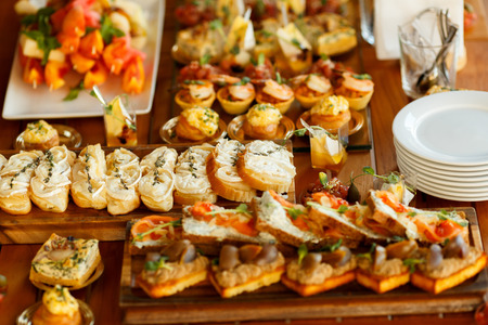 Catering Fourchette, buffet table, Canape, sandwiches and snacks on holiday table, sliced, fourchette catering table setting, aperitif Fourchette holidays wedding.の写真素材