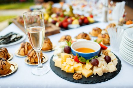 Cheese plate served with fruit and honeyの写真素材
