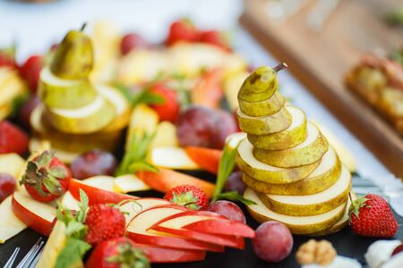 Fresh Sliced fruits on the holiday tableの写真素材