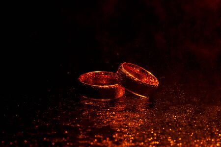 Beautiful gold wedding rings with water dropsの写真素材